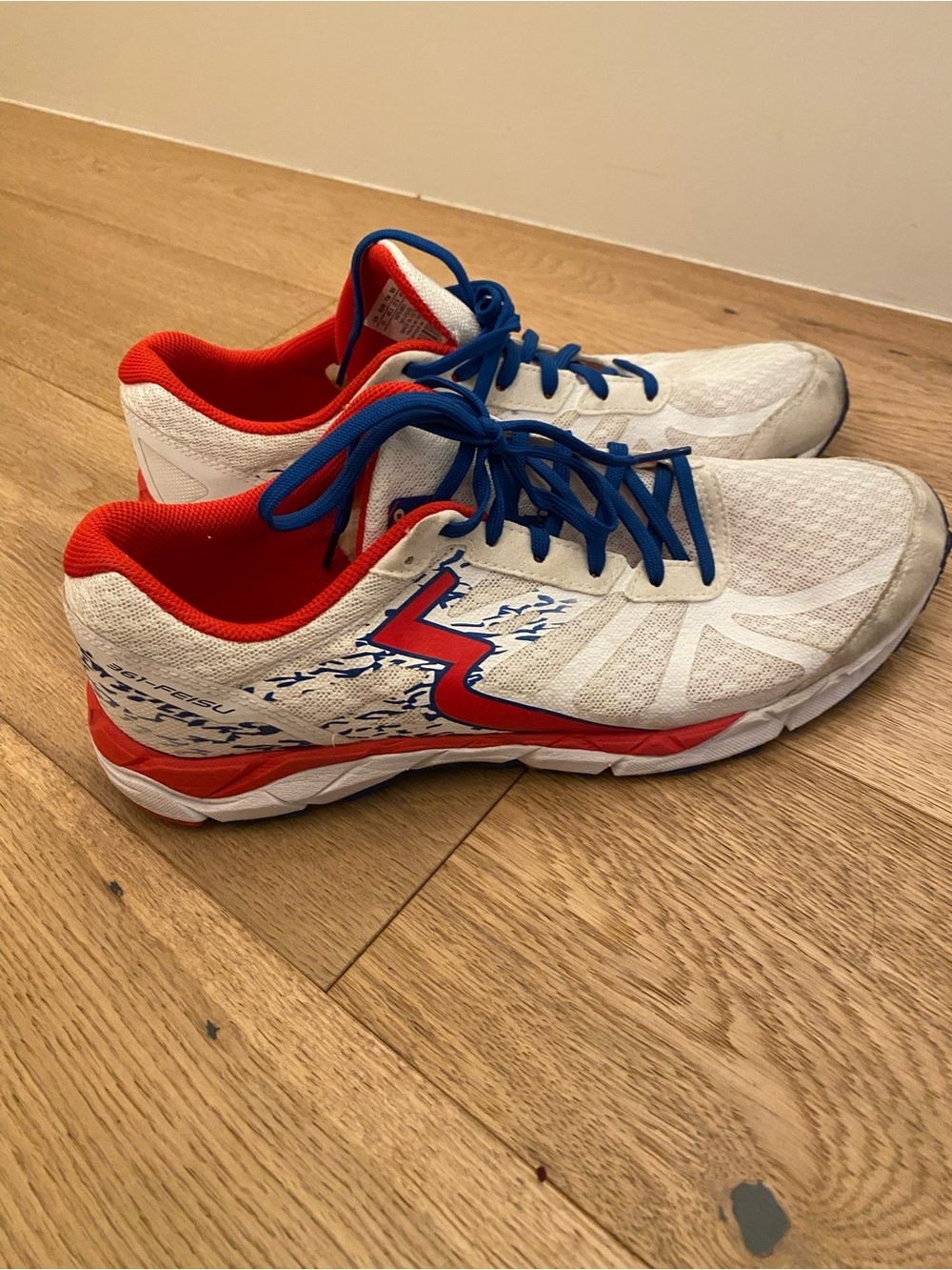 White Athletic Running Shoes with Red & Blue Accents